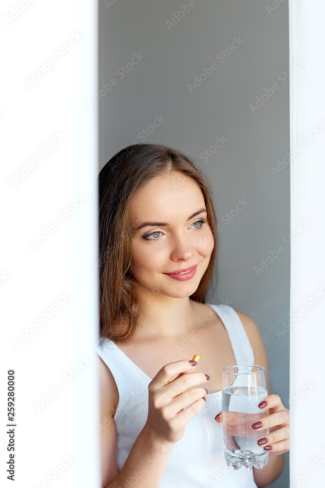 Beautiful Smiling Woman Taking Vitamin Pill. Dietary Supplement Beautiful Smiling Woman Taking Vitamin Pill. Dietary Supplement