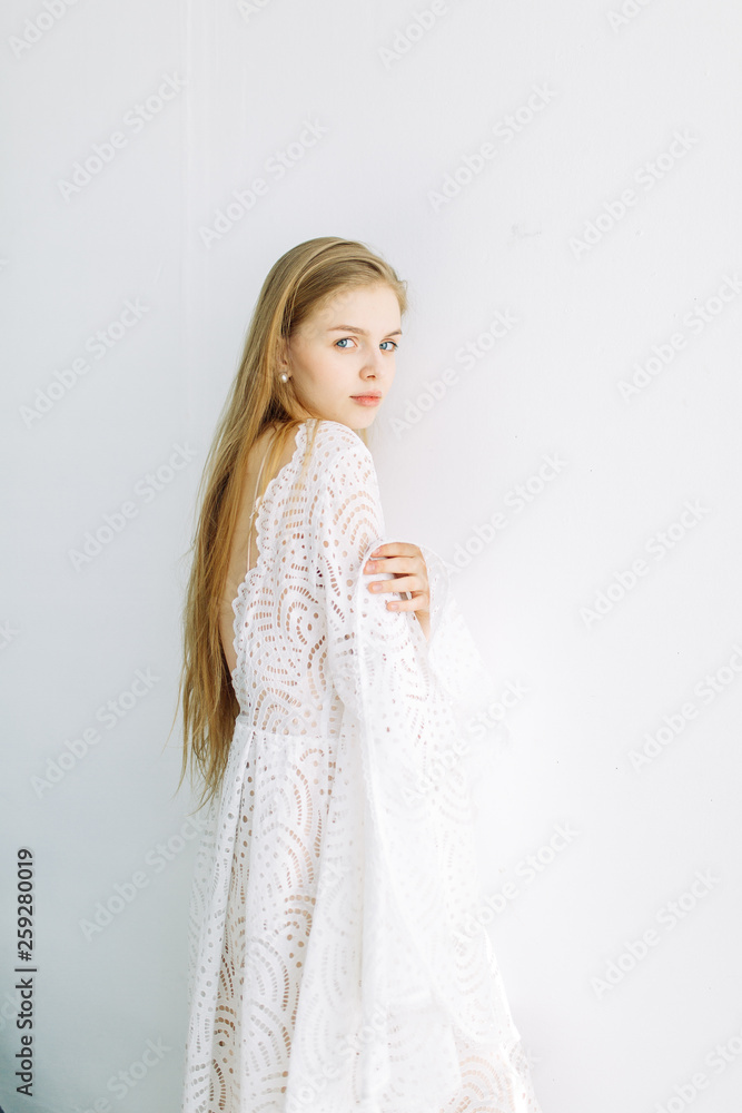Beautiful bride on a white minimalistic background. Wedding preparations in fine art. Beautiful bride on a white minimalistic background. Wedding preparations in fine art.