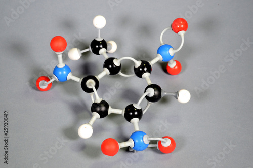 Molecule model of TNT (Trinitrotoulene). Red is oxygen, black is carbon, blue is nirogen and white is hydrogen. photo