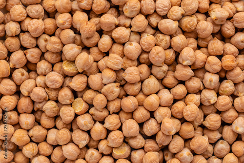 Chickpea in a white saucer on a gray concrete background