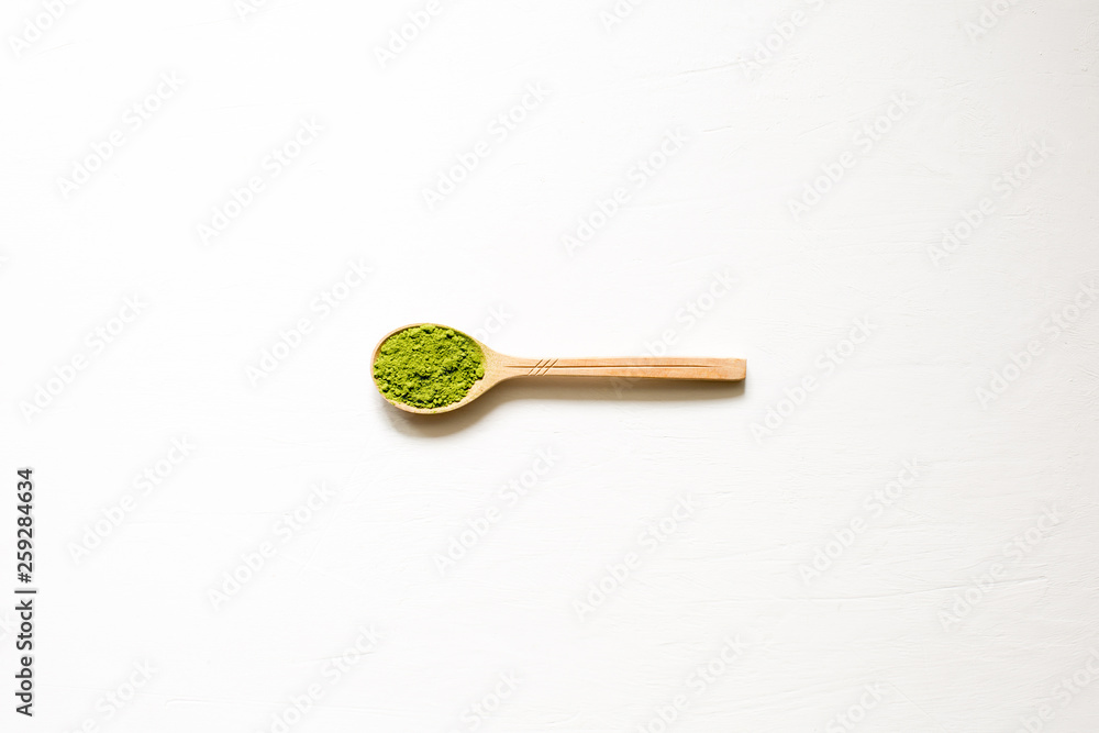 Matcha. Japanese powdered green tea in a spoon on a white background. Top view and copy space. Matcha. Japanese powdered green tea in a spoon on a white background. Top view and copy space.