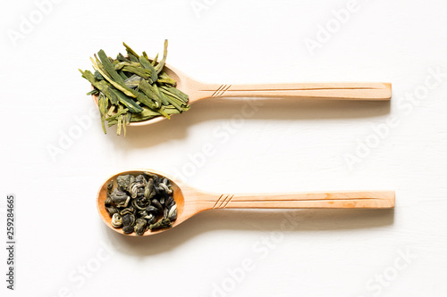 Biluochun and Longjing. Chinese leaf green tea in a spoon on a white background. photo
