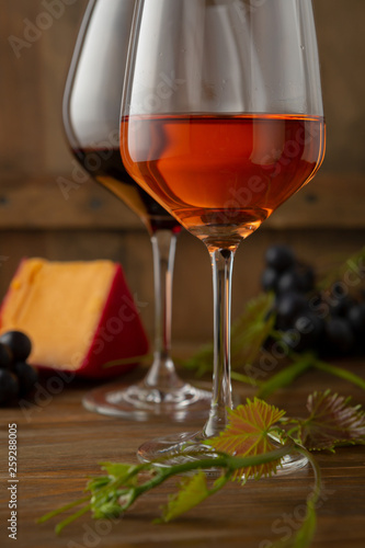 Two glasses of wine on rustic background