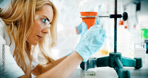 Female student of chemistry working in laboratory photo