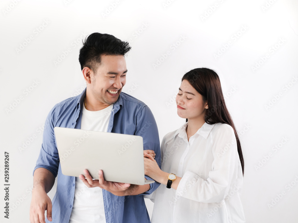Happy Asian couple shopping online with holding credit card and laptop and sitting at home together, lifestyle concept. Happy Asian couple shopping online with holding credit card and laptop and sitting at home together, lifestyle concept.