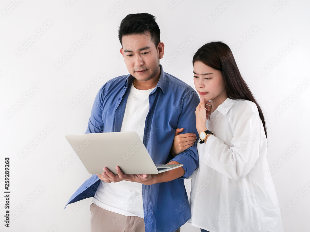 Happy Asian couple shopping online with holding credit card and laptop and sitting at home together, lifestyle concept. Happy Asian couple shopping online with holding credit card and laptop and sitting at home together, lifestyle concept.