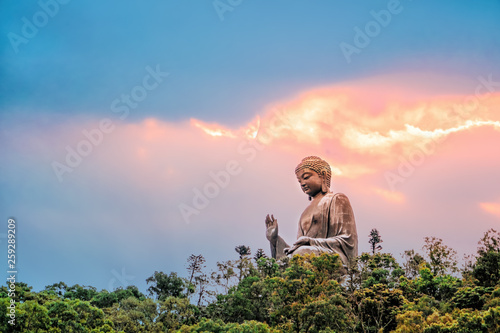 Giant Buddha of Po Lin Monastery at Lantau Island Hong Kong with wit background of sunset sky