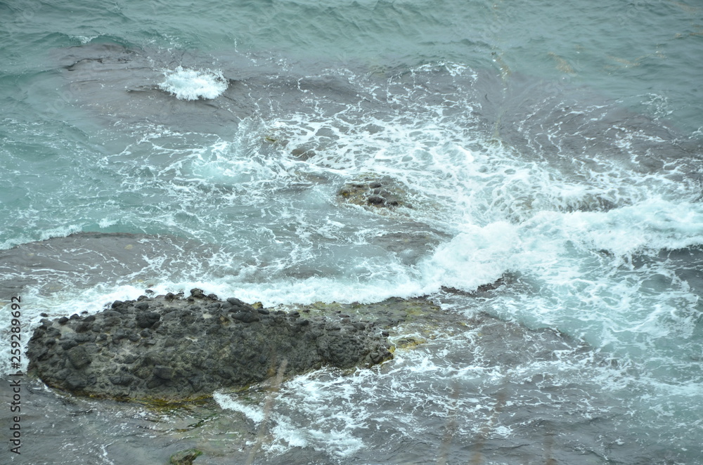 waves crashing on rocks