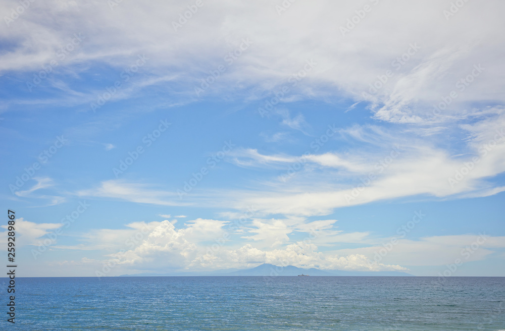 Wide view of the island of Bali and the Agung volcano on the horizon from the island of Lombok in Indonesia. 