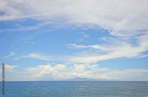 Wide view of the island of Bali and the Agung volcano on the horizon from the island of Lombok in Indonesia. 