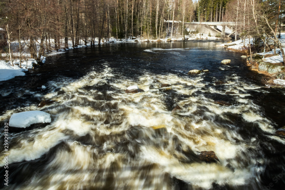 Long exposure photo. Rough river Jokelanjoki and stones in water, Kouvola, Finland. Long exposure photo. Rough river Jokelanjoki and stones in water, Kouvola, Finland.