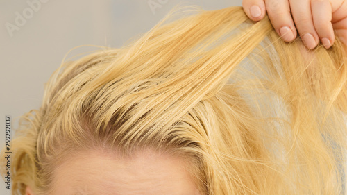 Blonde woman having greasy hair