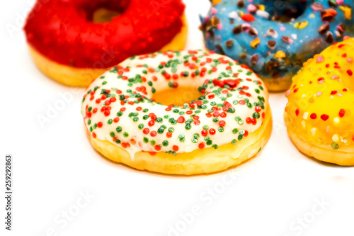 Sweet tasty donuts with colorful sprinkles isolated on white background