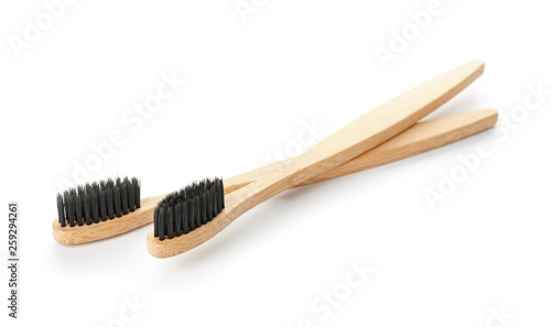 Wooden toothbrushes on white background