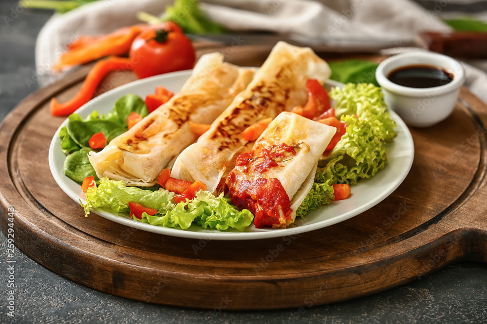 Plate with tasty fried spring rolls on table Plate with tasty fried spring rolls on table