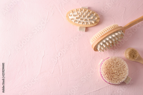 Massage brushes on color background