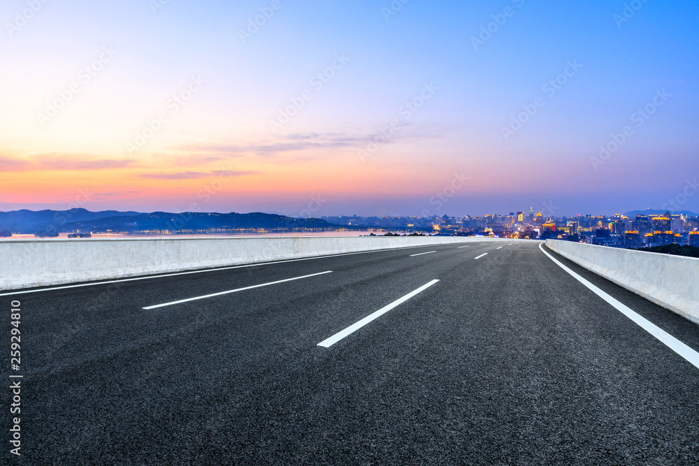 Fototapeta premium Asphalt highway passing through the city above in Hangzhou at sunset