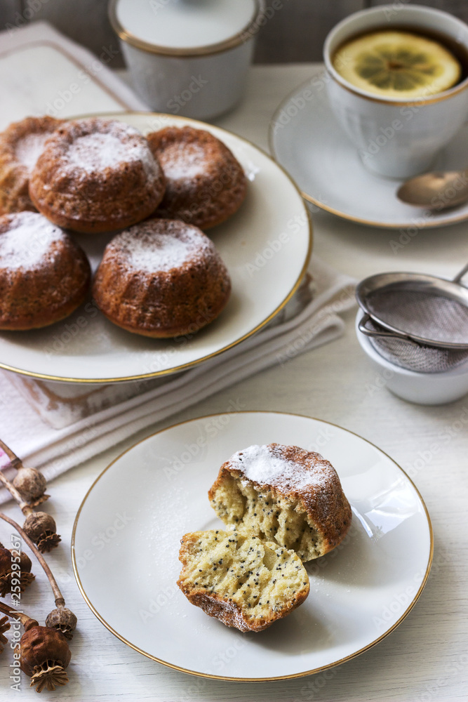 Lemon poppy biscuit muffins for tea on a light background. Lemon poppy biscuit muffins for tea on a light background.