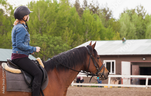 Teenage girl rides brown horse
