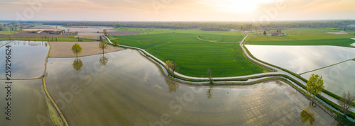 Flooded fields for rice cultivation in the Po Valley, Italy. Panoramic aerial view. Typical countryside landscape of northern Italy with dirt roads, fields and ancient farms. photo
