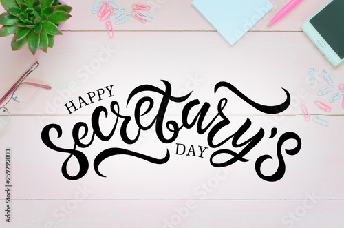 Woman desk with pink pen, paper, coffee cup, glasses and succulent. Hand written lettering Happy Secretary's day