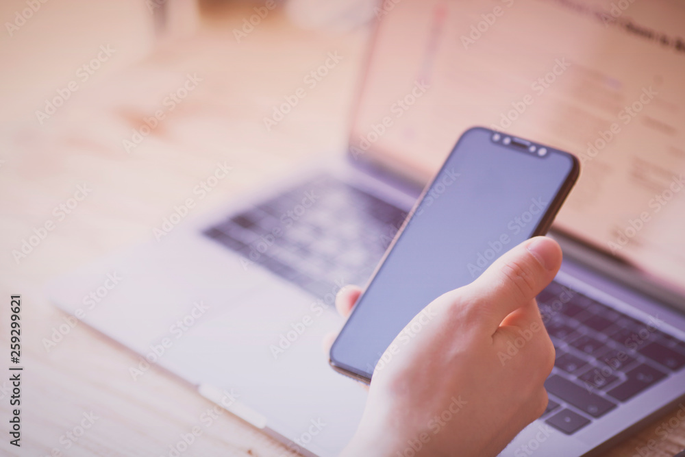 Businessman working with modern devices. Close up male hands, smart phone and laptop. Business, technology, office concept. Businessman working with modern devices. Close up male hands, smart phone and laptop. Business, technology, office concept.