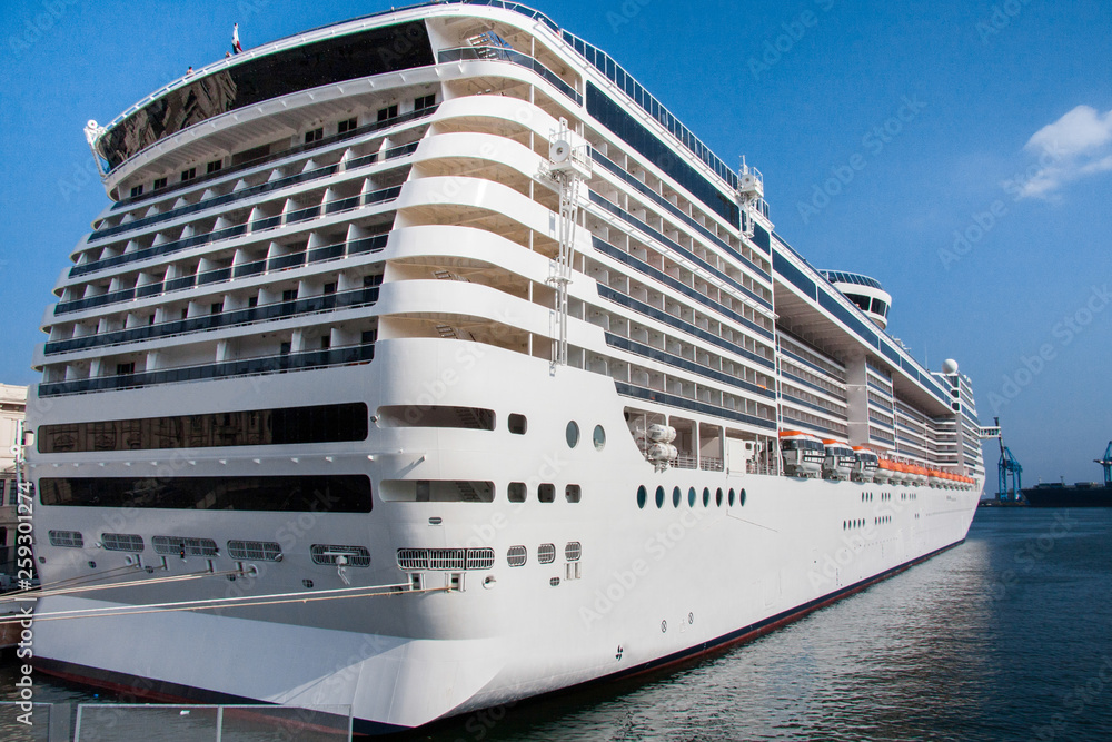 Naklejka premium view of a cruise ship anchoring in the port of genoa in italy.