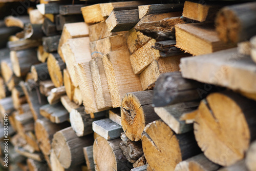 Dry chopped firewood of solid pine and birch wood in a pile.