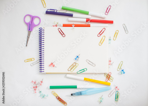 Bright stationery for study: paper, felt-tip pens, scissors, paper clips