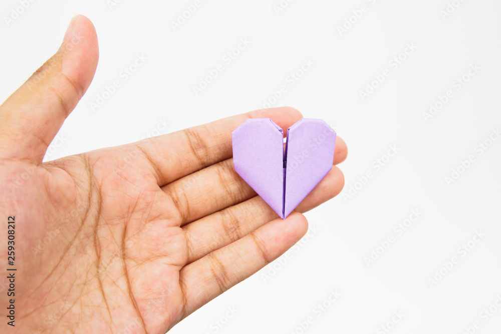 Hands holding paper heart origami isolated on white background
