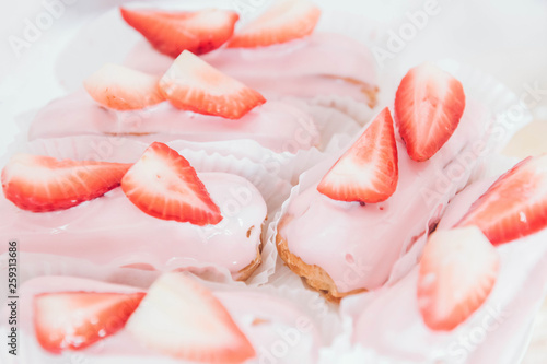Sweet background. Eclairs with strawberries