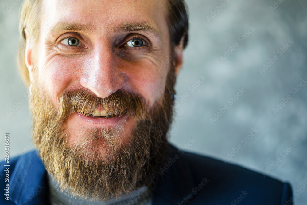 Close Up Portrait of A Happy Man with a Beard is Talking and Laughing. Joyful Communication Concept Close Up Portrait of A Happy Man with a Beard is Talking and Laughing. Joyful Communication Concept