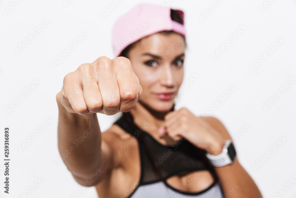Beautiful young amazing strong sports fitness woman boxer posing isolated over white wall background make exercises. Beautiful young amazing strong sports fitness woman boxer posing isolated over white wall background make exercises.