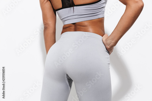 Young amazing strong sports fitness woman boxer lower isolated over white wall background.