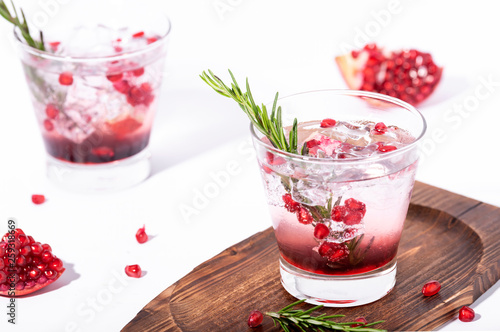 Pomegranate juice with ripe pomegranate on white background. summer drink.