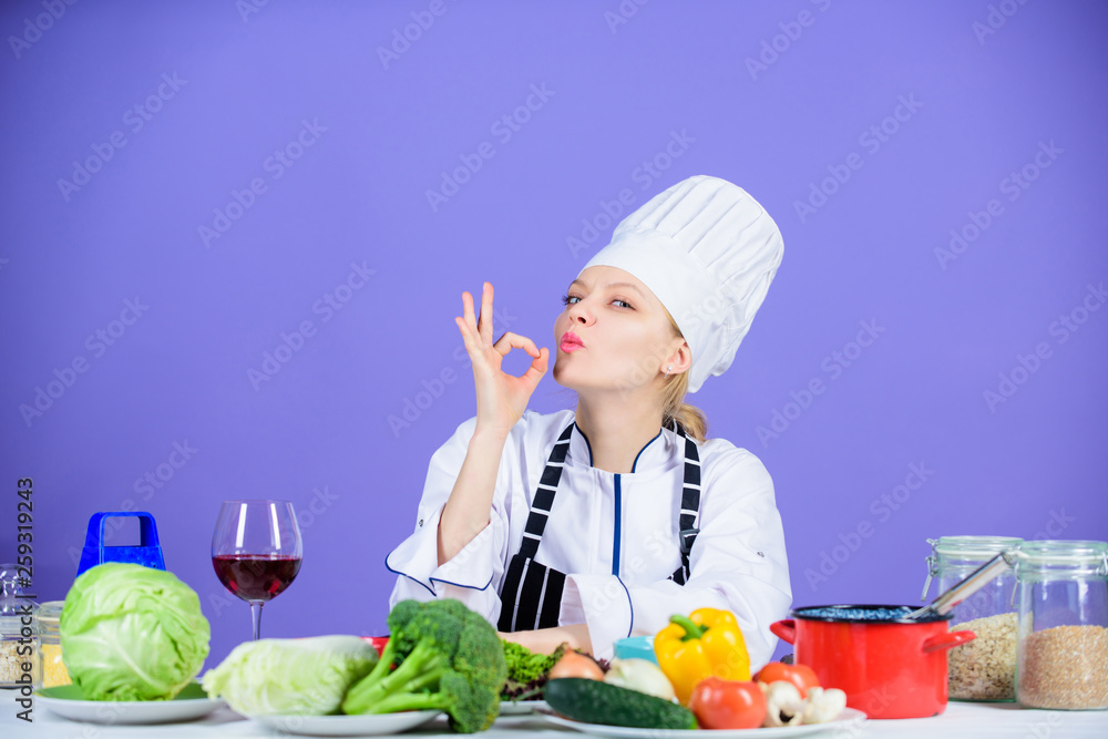 Yummy cooking. Kitchen maid showing OK gesture. Pretty woman cooking in restaurant kitchen. Professional cook confident in her cooking skills. Vegetarian cooking Yummy cooking. Kitchen maid showing OK gesture. Pretty woman cooking in restaurant kitchen. Professional cook confident in her cooking skills. Vegetarian cooking