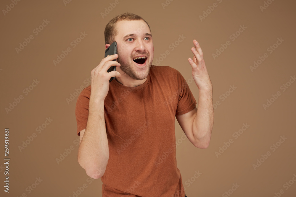 a young man is having fun talking on the phone a young man is having fun talking on the phone