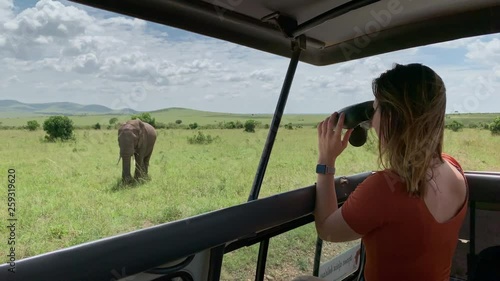 Woman on a safari trip in Masai Mara spotting elephants