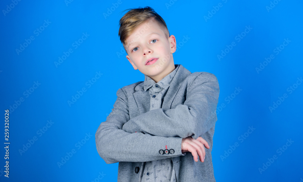 Serious young man. Small boy on blue background. Confident little boy. Cute boy child keeping arms crossed. Adorable preschooler boy or schoolboy in formal wear Serious young man. Small boy on blue background. Confident little boy. Cute boy child keeping arms crossed. Adorable preschooler boy or schoolboy in formal wear