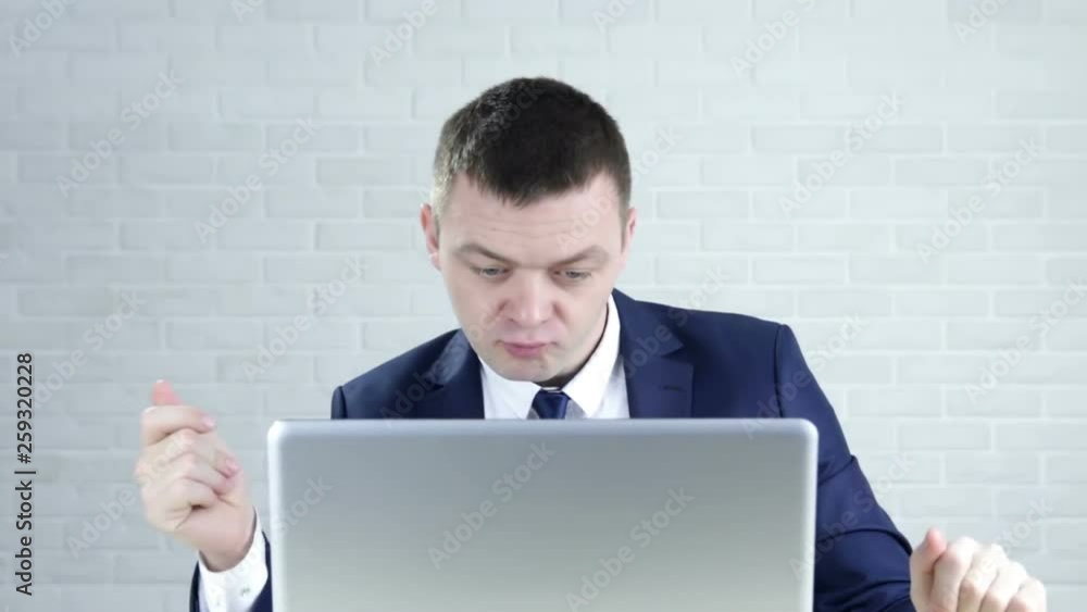 Happy, funny businessman with laptop dancing by desk in office Happy, funny businessman with laptop dancing by desk in office
