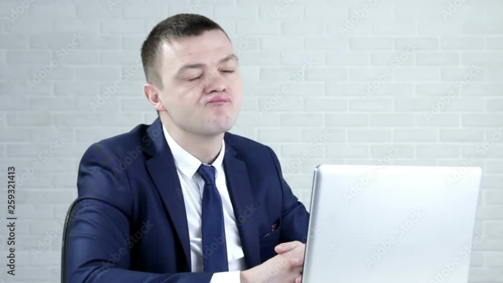 Young attractive businessman thinking at computer laptop desk Young attractive businessman thinking at computer laptop desk