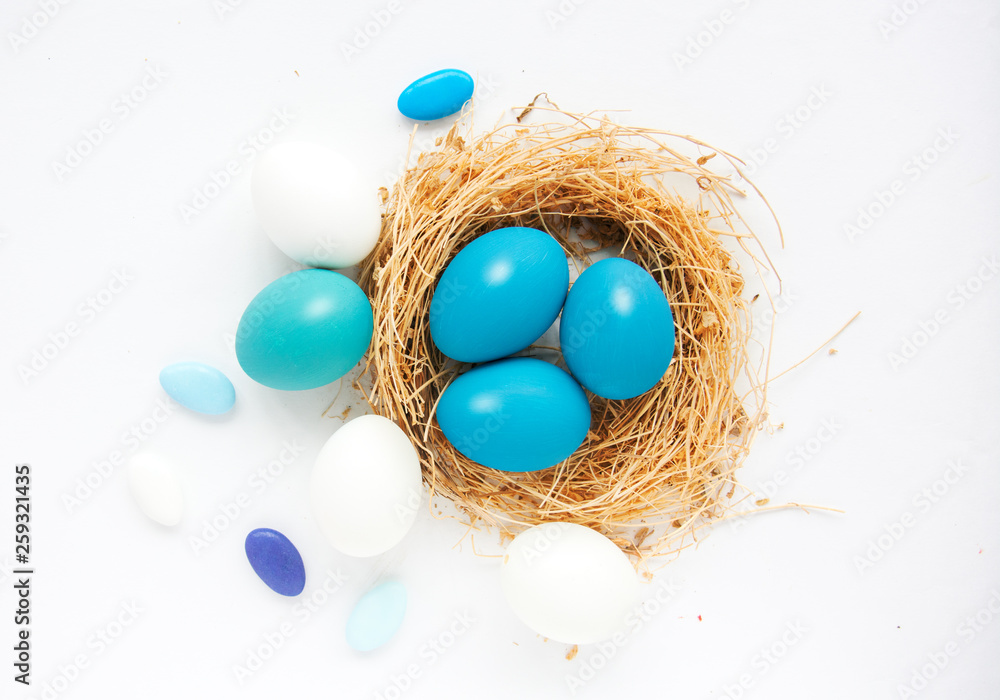 Bright blue colored Easter eggs in nest on wooden background, selective focus image. Happy Easter card Bright blue colored Easter eggs in nest on wooden background, selective focus image. Happy Easter card