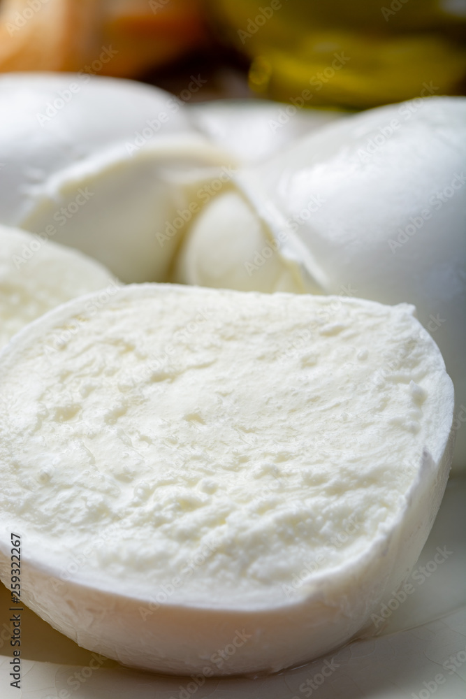 Balls and pieces of buffalo mozzarella, soft Italian scheese made from the milk of Italian Mediterranean buffalo Balls and pieces of buffalo mozzarella, soft Italian scheese made from the milk of Italian Mediterranean buffalo