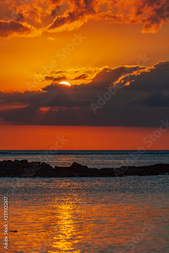 The burning sunset over Indian ocean paints water and sky in red color  Mauritius island