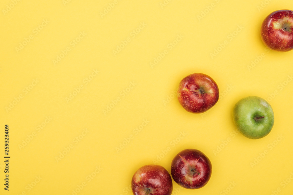 Top view of ripe fresh apples on yellow surface Top view of ripe fresh apples on yellow surface