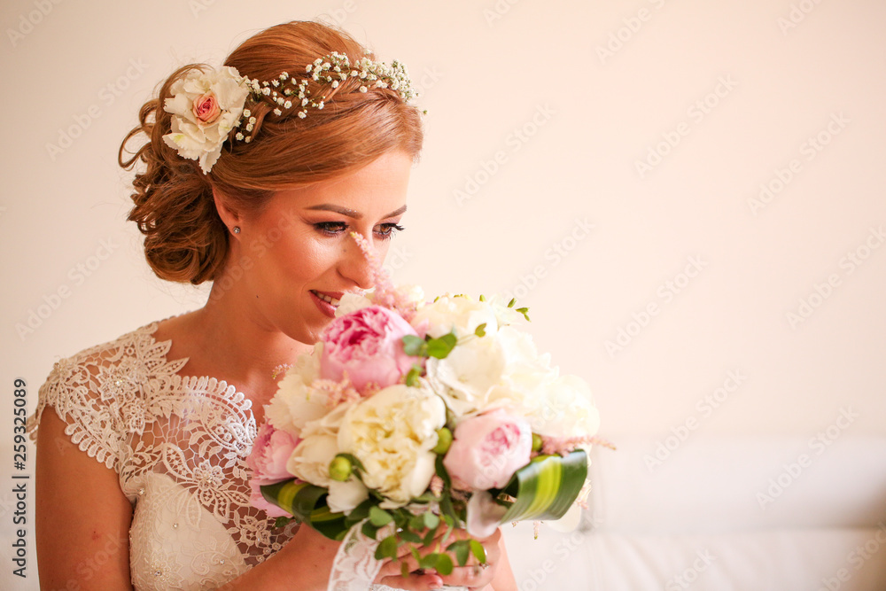 Happy blonde woman posing in w2edding dress with bouquet of flowers in hands Happy blonde woman posing in w2edding dress with bouquet of flowers in hands