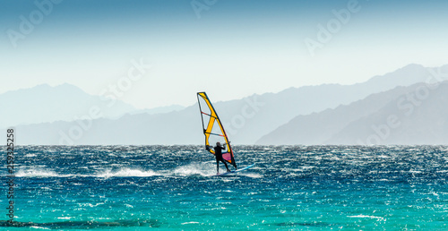 windsurfer rides on a background of high mountains in Egypt Dahab South Sinai