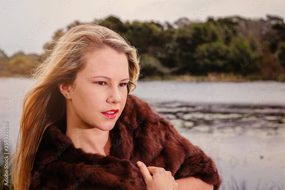 Stunning blonde model in a fur shoulder cape Stunning blonde model in a fur shoulder cape