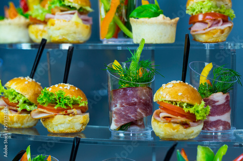 Mini canapes with cheese salads meat and seafood in plastic cups. 