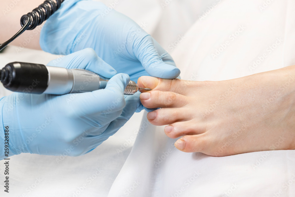 Process of pedicure of female legs at beauty salon Process of pedicure of female legs at beauty salon